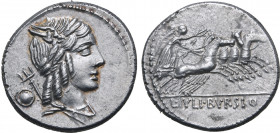 L. Julius Bursio AR Denarius. Rome, 85 BC. Male head to right, with attributes of Apollo, Mercury and Neptune; round shield behind / Victory driving q...