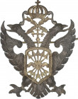 Insignia. (1936-1975). FALANGE. Latón. Ø 45 x 33 mm. Insignia de Falange y tradición carlista con yugo y estrellas, cruz de borgoña coronada y cruz de...