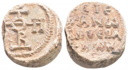 Byzantine Lead Seal ( 7th- 8th century)
Obv: Cruciform monogram 
Rev: 4 (Four) lines of text. Pearl border.
(15 gr, 20,9 mm diameter)