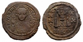 Justinian I (527-565). Æ 40 Nummi (35mm, 19.76g, 6h). Nicomedia, year 20 (546/7). Helmeted and cuirassed bust facing, holding globus cruciger and shie...