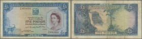 Rhodesia & Nyasaland: 5 Pounds August 15th 1958, P.22a with several handling traces like folds and stained paper. Condition: F