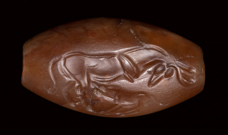 A greek late minoan agate intaglio seal. A cow nursing a calf.

1450 - 1300 B....