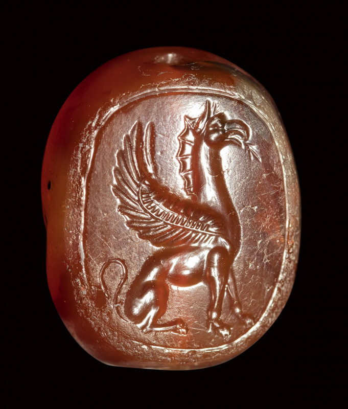 An early classical greek carnelian scaraboid intaglio. A seated griffin. 

5th...