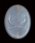 A fine late classical greek blue chalcedony scaraboid seal. Two molossian dogs.