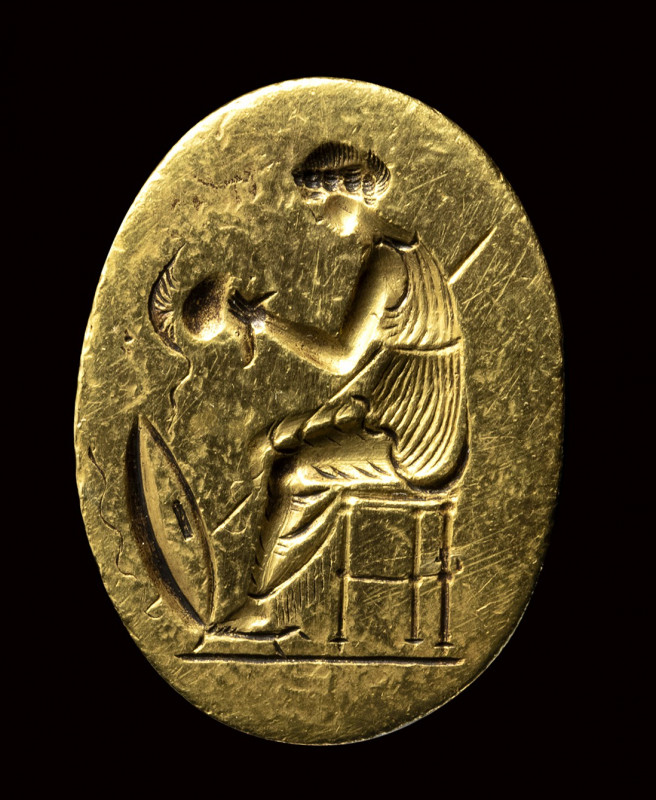 A fine classical greek engraved gold ring. Seated Athena with weapons. 

Late ...