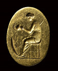 A fine classical greek engraved gold ring. Seated Athena with weapons.