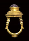 A late hellenistic architectural gold ring with stepped bezel set with amethyst and garnet.