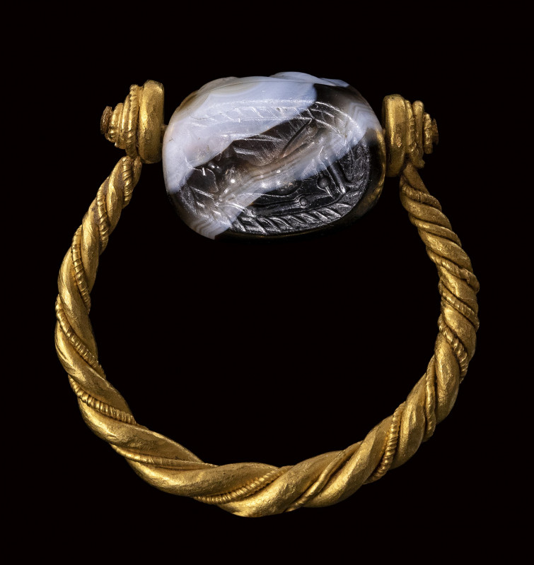 An etruscan banded agate scarab engraved seal set in a gold swivel ring. Warrior...