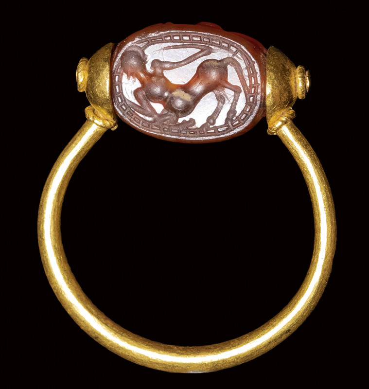 An etruscan carnelian scarab set in a gold swivel ring. Centaur. 

4th century...