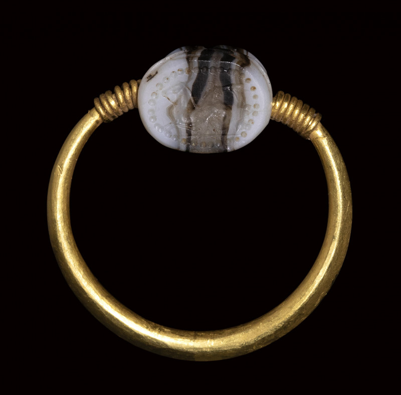 An etruscan banded agate scarab engraved seal set in a gold swivel ring. Sea-hor...