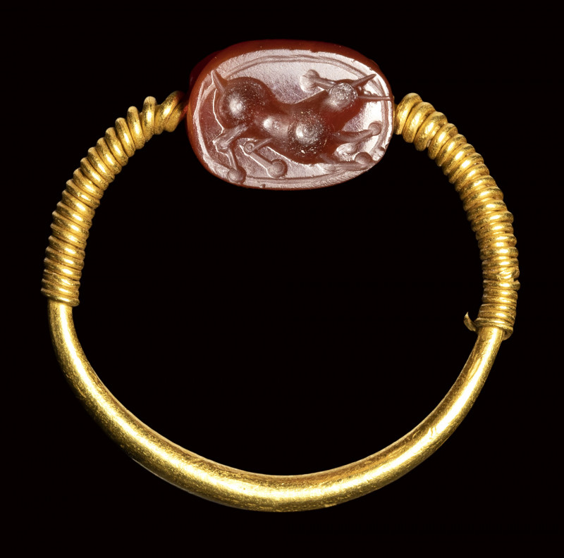 An etruscan carnelian scarab intaglio set in a gold swivel ring. Bull. 

3rd c...