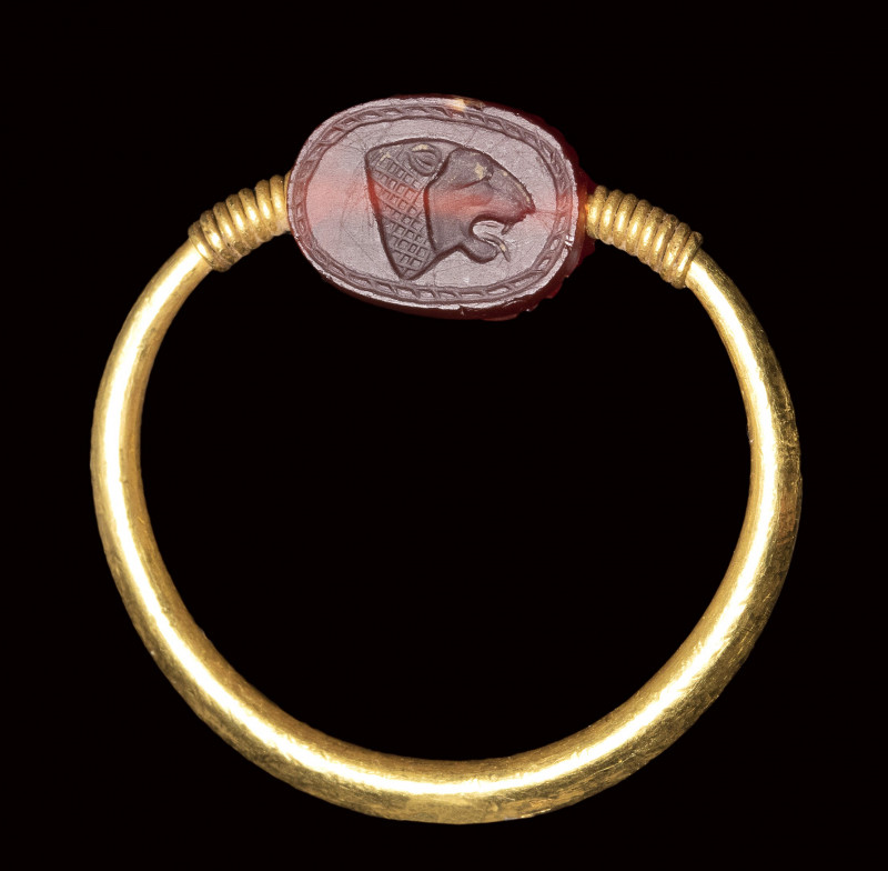 A rare small Phoenician carnelian scarab set in a gold swivel ring. Lion head.
...
