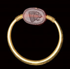 A rare small Phoenician carnelian scarab  set in a gold swivel ring. Lion head.