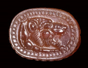 An etruscan carnelian engraved scarab. Lion forepart.