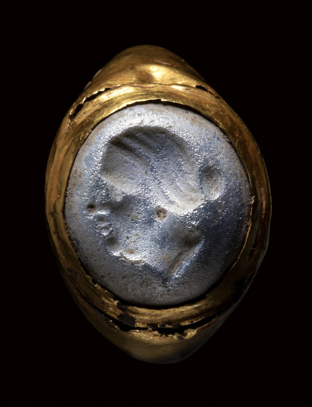 A greek Hellenistic gold ring set with a glass intaglio. Female portrait.

2nd...