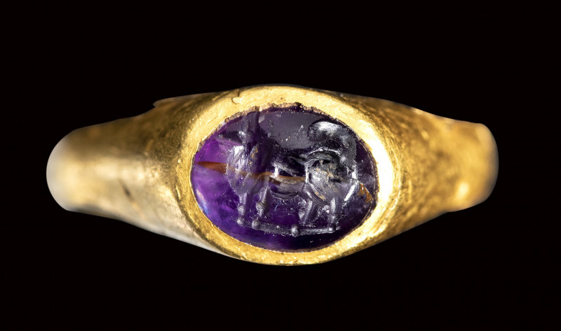 A greek hellenistic gold ring set with an amethyst intaglio. Maltese dog.

4th...