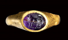 A greek hellenistic gold ring set with an amethyst intaglio. Maltese dog.