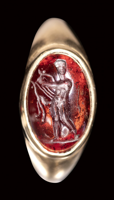 An hellenistic garnet intaglio set in a gold ring. Apollo.

2nd century B.C.
...