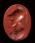 A large greek hellenistic red jasper intaglio. Bust of Athena.