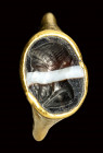 A late hellenistic gold ring set with a banded agate intaglio.  Bust of Herm.