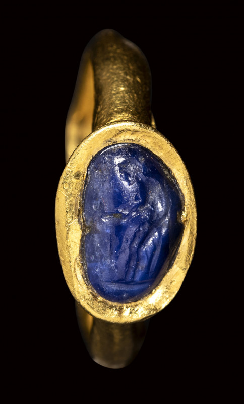 A rare late hellenistic sapphire intaglio set in a gold ring. Venus at the fount...