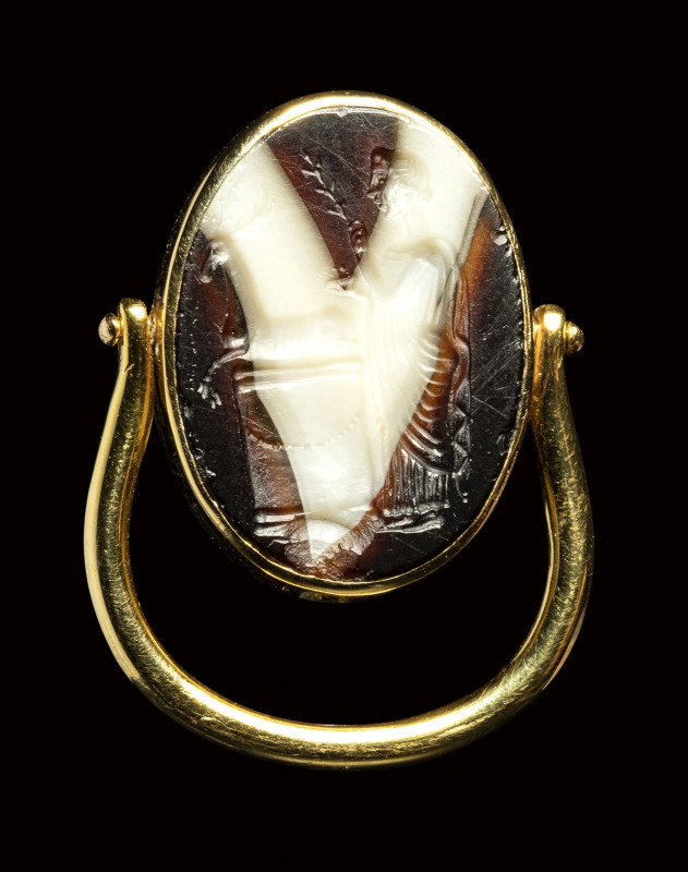A large roman italic banded agate intaglio set in a swivel gold ring. Sacrifice ...