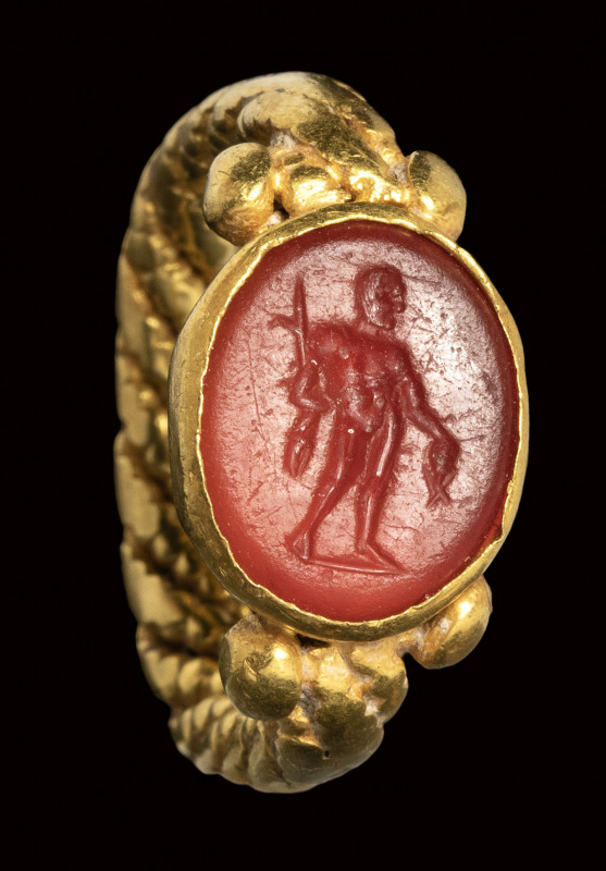 A roman italic carnelian intaglio set in a barbaric gold ring. Perseus 

2nd c...