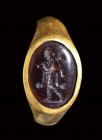 A late italic garnet intaglio set in a gold ring. Omphale.