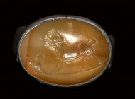 A roman italic agate intaglio set in a silver ring. Boar with a dog.