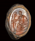A fine roman carnelian intaglio set in a fragmentary iron ring. Diomedes with Palladium.