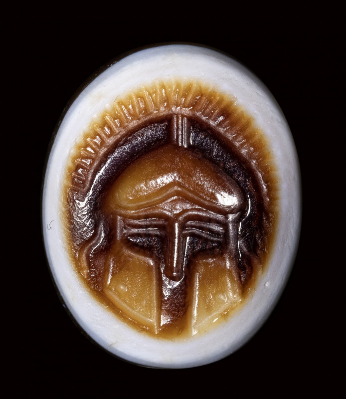 A greek hellenistic sardonyx pierced intaglio. Frontal helmet. 

3rd - 2nd cen...