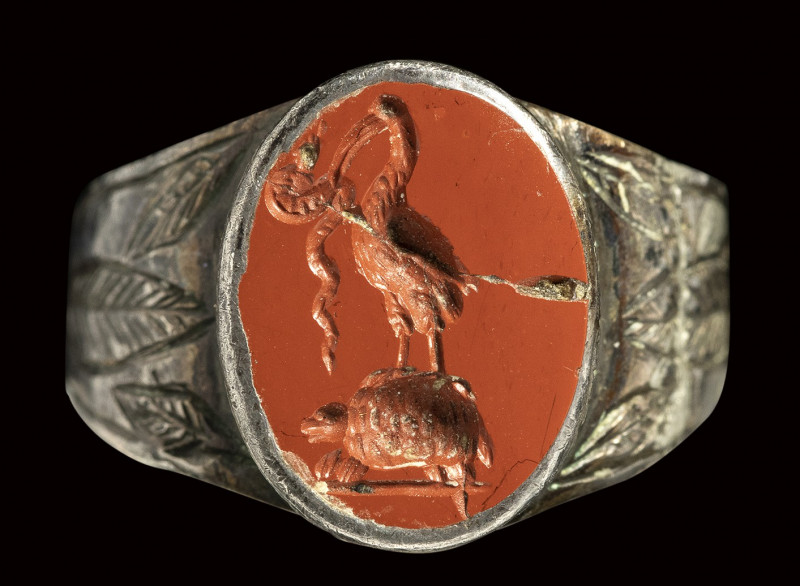 A roman red jasper intaglio mounted on a silver ring. Ibis on a turtle with a sn...