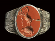 A roman red jasper intaglio mounted on a silver ring. Ibis on a turtle with a snake.