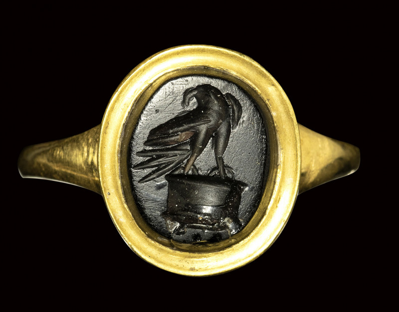 A roman late republican obsidian intaglio mounted on a modern gold ring. Eagle o...