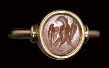 A roman carnelian intaglio set in a gold ring. Eagle.