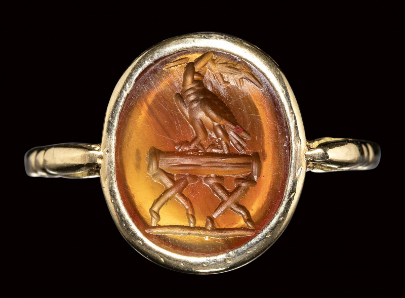 A roman carnelian intaglio mounted on a modern gold ring. Eagle on a stand. 

...
