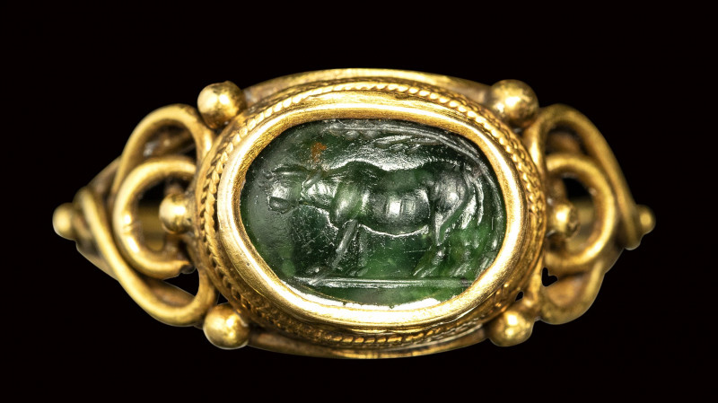 A roman green chalcedony intaglio set in a gold ring. Heafer under a tree.

2n...