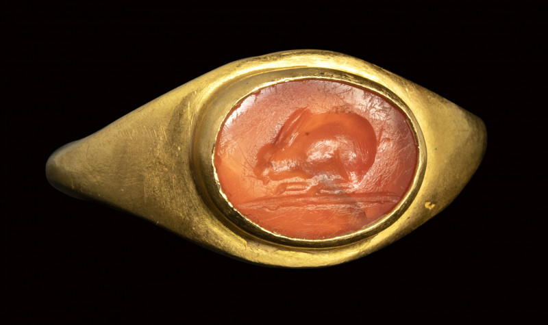 A roman carnelian intaglio set in an ancient gold ring. Rabbit.

2nd - 3rd cen...