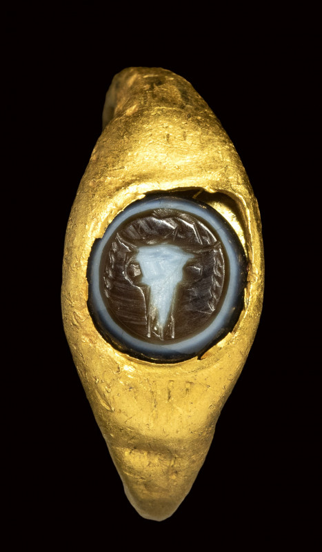 A roman gold ring set with a three-layered agate intaglio. bucrane. 

1st - 2n...
