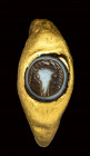 A roman gold ring set with a three-layered agate intaglio. bucrane.