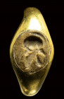 A roman jasper intaglio mounted in a later gold ring. Helmet.