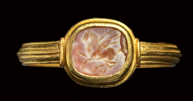 A roman burnt agate intaglio set in a gold ring. Pegasus.

2nd century A.D.
...