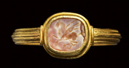 A roman burnt agate intaglio set in a gold ring. Pegasus.