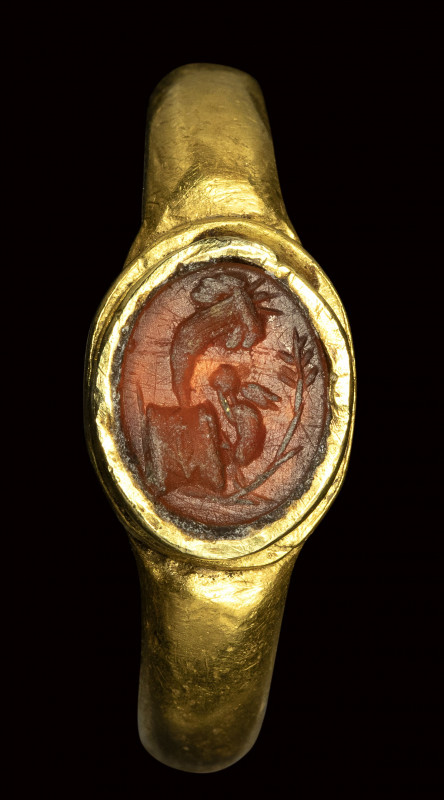 A roman carnelian intaglio set in a gold ring. Allegorical emblema. 

2nd cent...