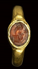 A roman carnelian intaglio set in a gold ring. Allegorical emblema.