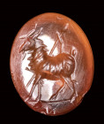 A roman carnelian intaglio. Goat with thyrsus.