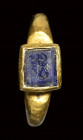 A late roman gold ring set with a lapis lazuli intaglio. Scorpio.