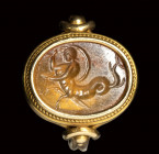A roman carnelian intaglio set in a gold ring. Tryton.