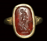 A fine early roman carnelian intaglio set in a gold ring. Omphale.