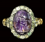 A fine roman amethyst intaglio set in a gold ring with diamonds. Seated Mercury with attributes.
